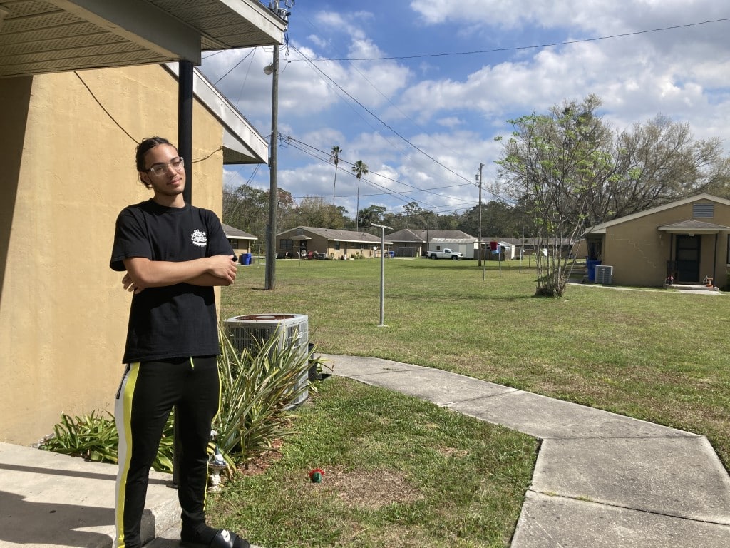 An images shows Academy Place Villas resident Xavi Muniz on his doorstep.