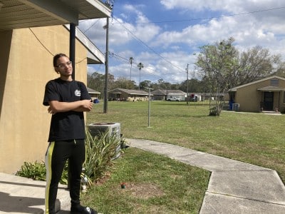 An images shows Academy Place Villas resident Xavi Muniz on his doorstep.