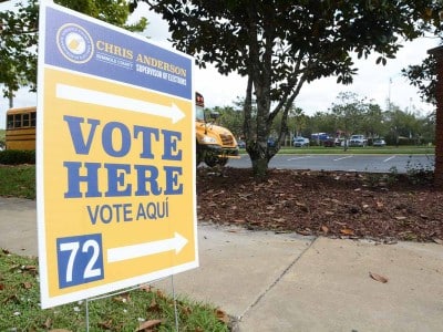 A local sign summons residents to vote. Election results Oviedo candidate drops out